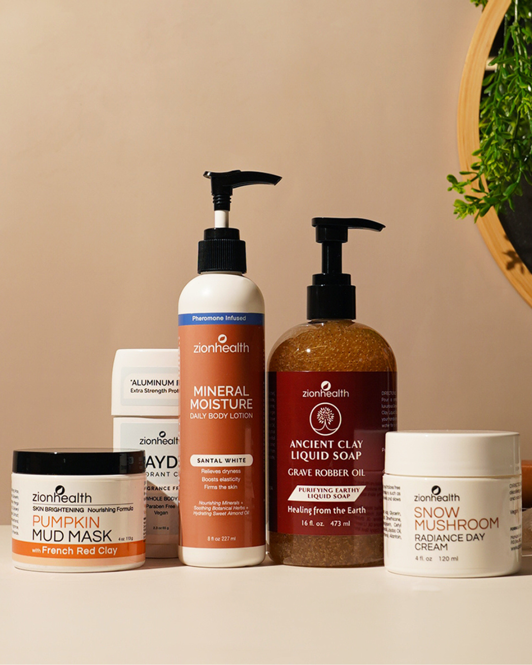Zion Health skincare and body care products displayed together on a beige background.